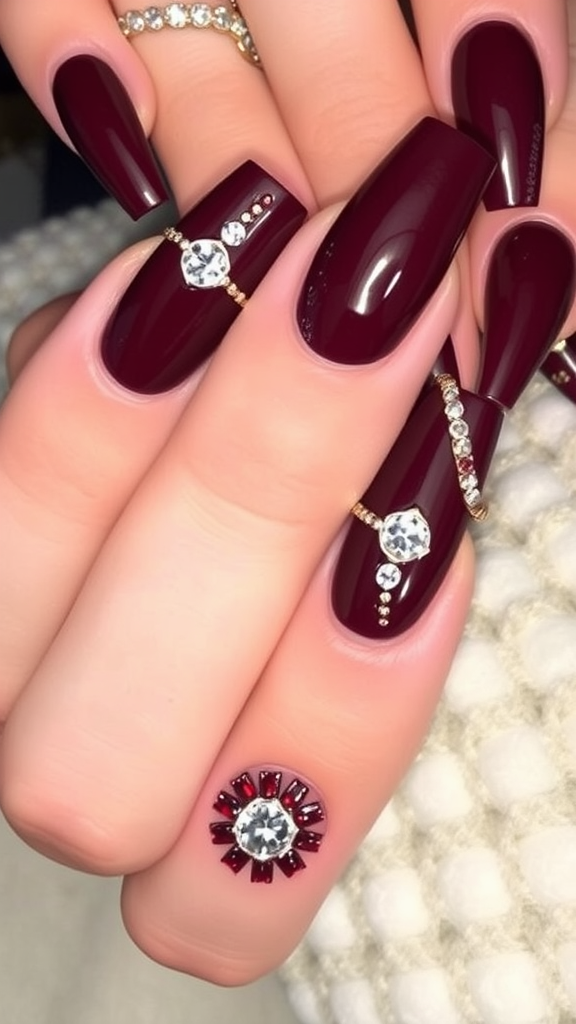 Burgundy nails with jewel accents and gold detailing