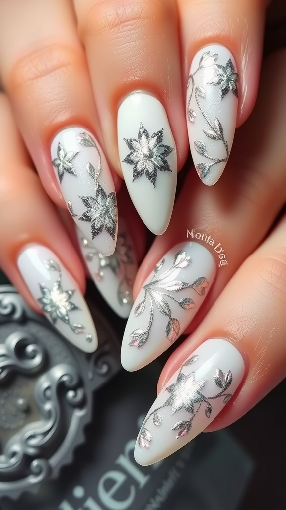 Elegant winter floral nail design with silver accents on a white background.