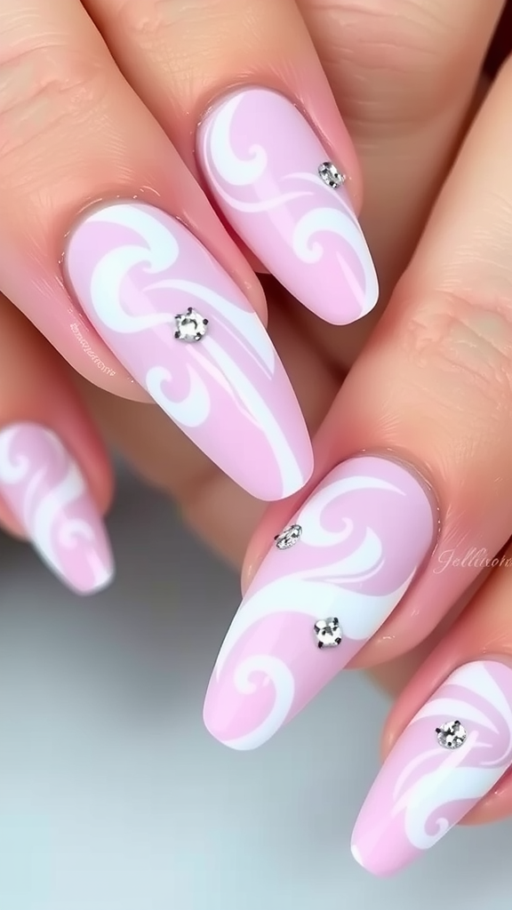 Nails featuring pastel pink and white swirls with decorative gems