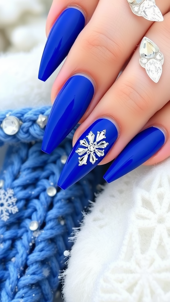 Close-up of royal blue nails with diamond accents on a cozy knitted background