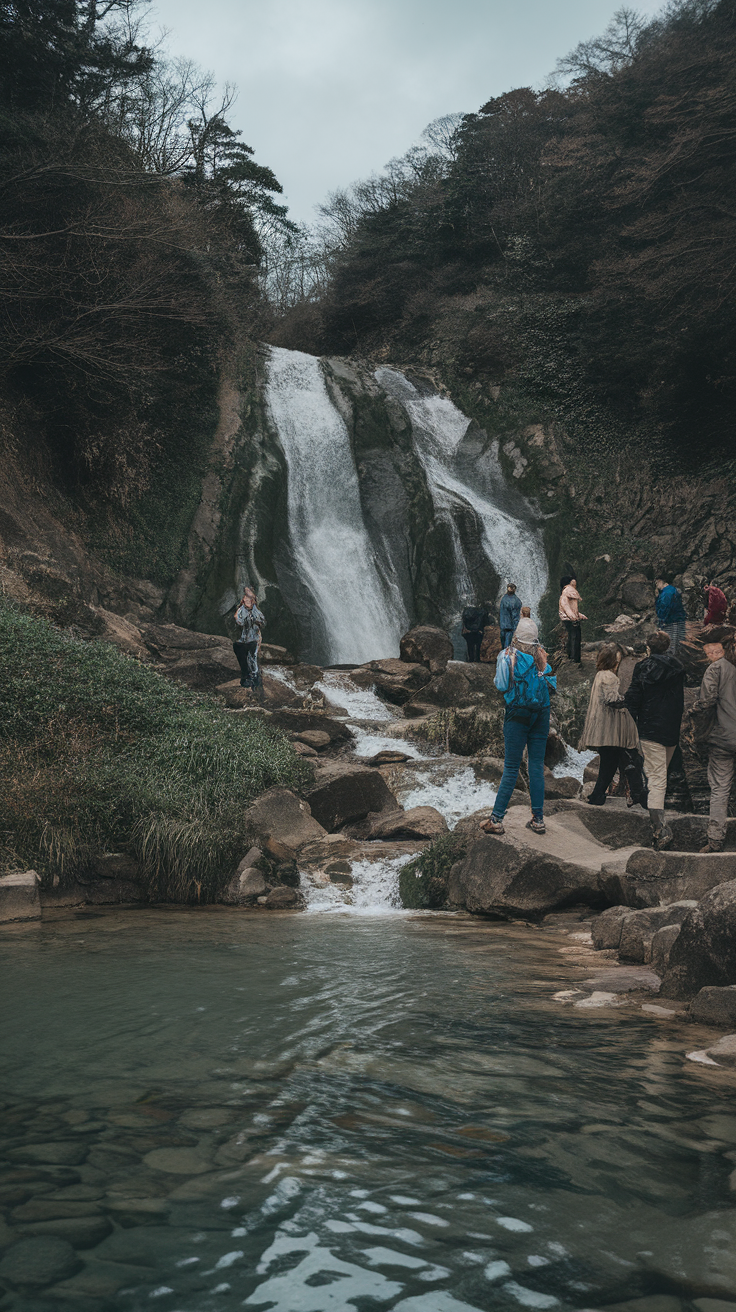 A waterfall in Okutama with visitors enjoying the scenery.