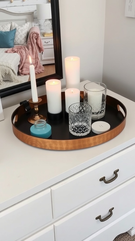 Decorative tray with candles and jars on a dresser