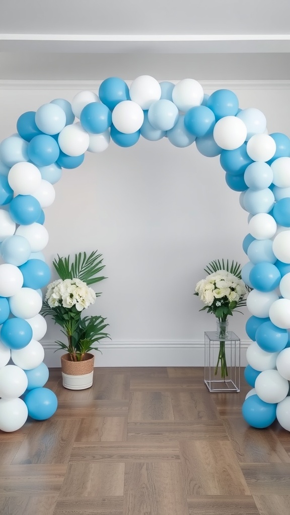 A balloon garland arch in blue and white colors with flowers on either side