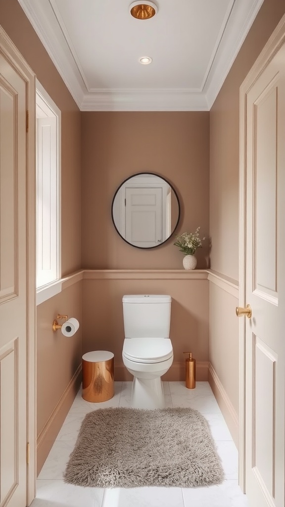 Small bathroom with warm taupe walls, white fixtures, and gold accents