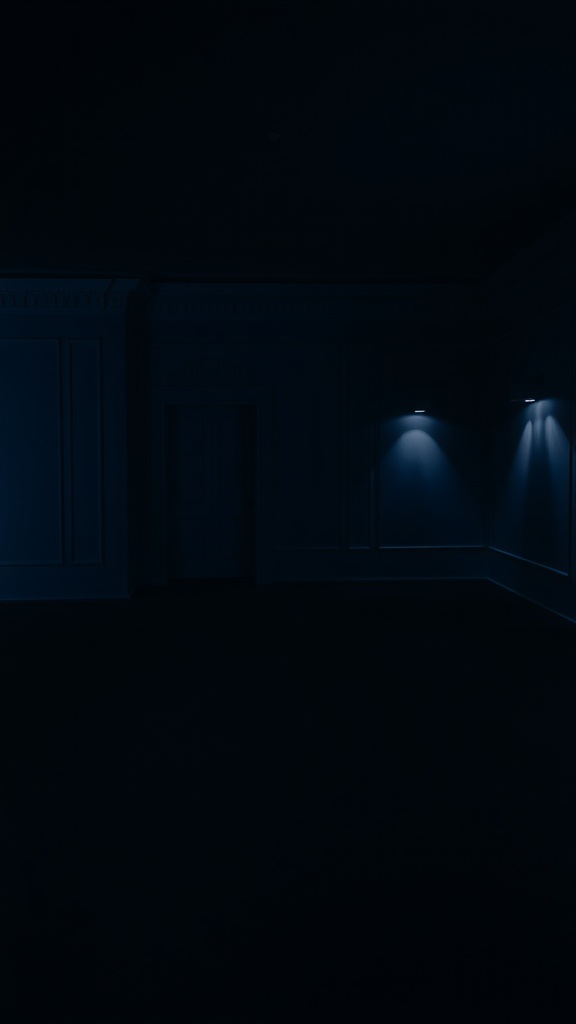 A dimly lit room with deep indigo walls and subtle lighting