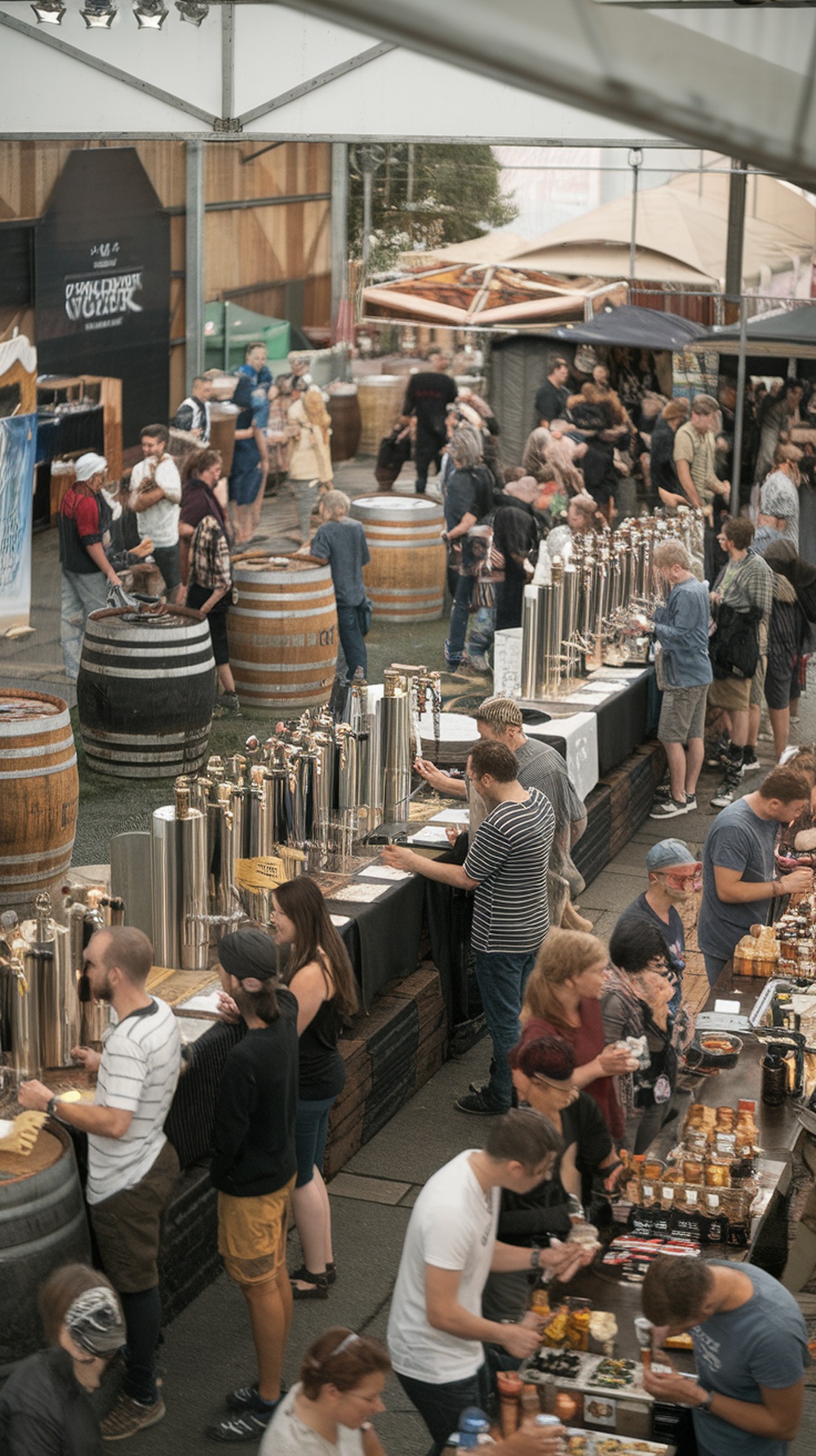 Crowd enjoying local craft beer at a festival with various beer taps and barrels.