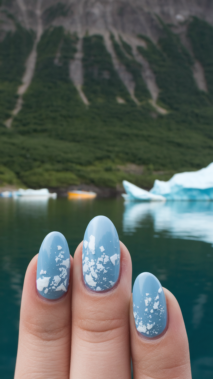 Acrylic nails featuring blue fjord water designs with waves and rocks.