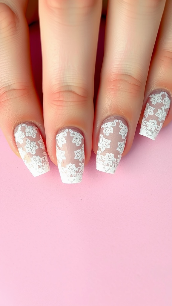 Close-up of nails with delicate lace designs on a pink background.