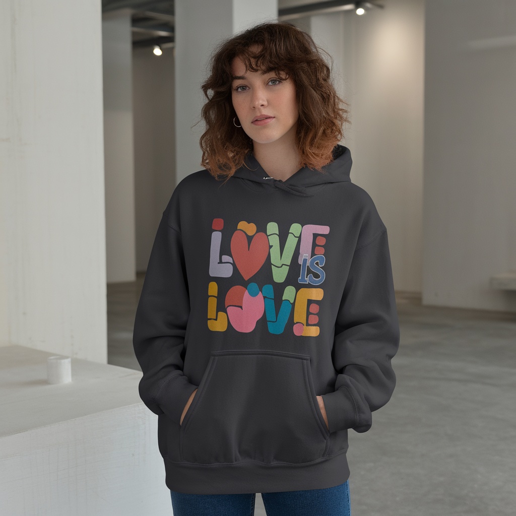 A person wearing a hoodie that says 'Love Is Love' in colorful letters.