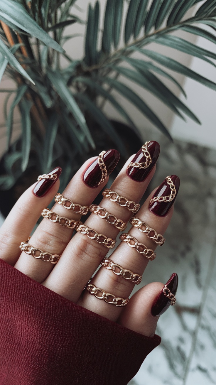 A hand with dark cherry red nails adorned with gold chains.