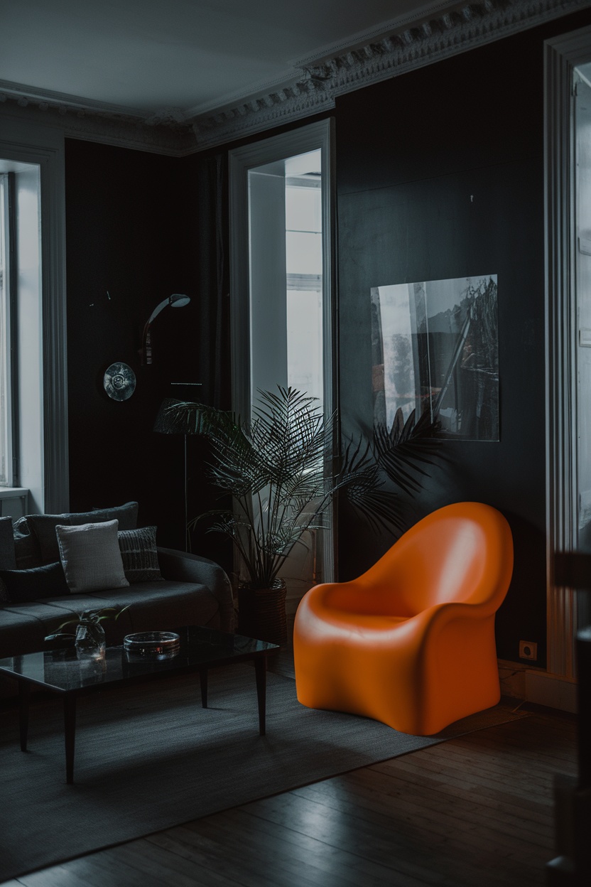 A cozy living room with dark walls, featuring an orange chair, a grey sofa, and a plant.