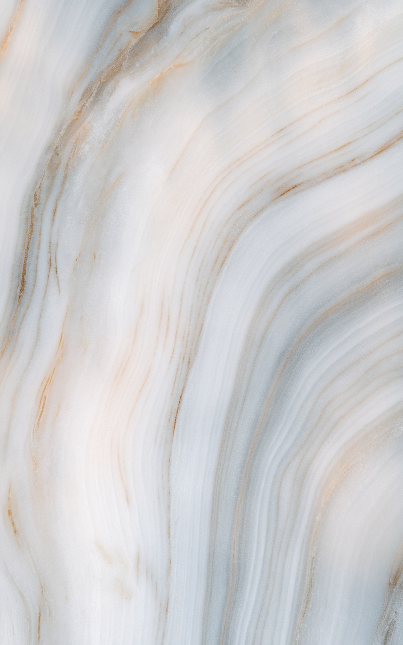 A close-up of elegant marble textures with soft waves and subtle colors.