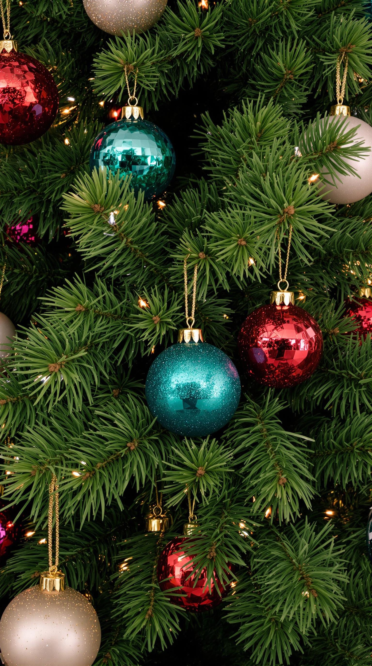 Close-up of a pine tree branch with colorful ornaments