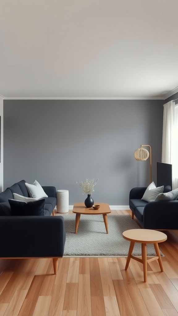 Cozy Scandinavian living room with black sofas, wood accents, and a gray wall.