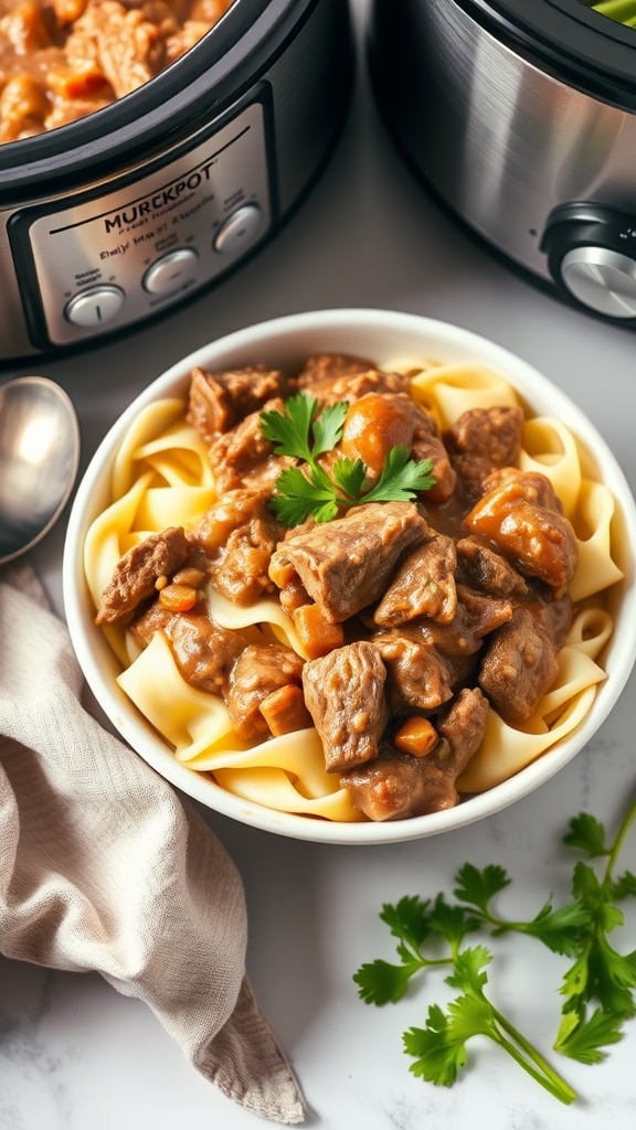 A bowl of beef stroganoff with noodles, garnished with parsley, next to a slow cooker.