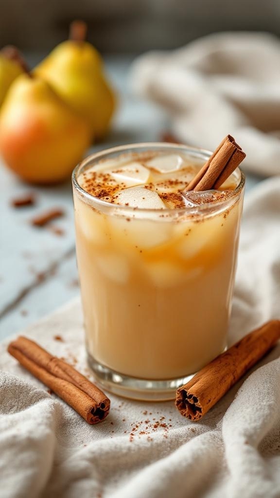 A refreshing pear cinnamon mocktail served in a glass with cinnamon sticks and fresh pears in the background.