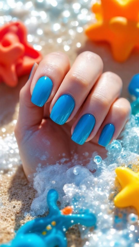 Close-up of electric blue nails with a beach background
