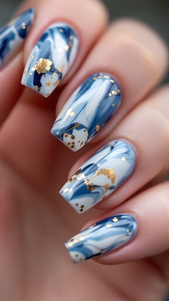 Close-up of blue marble effect nails with gold accents.