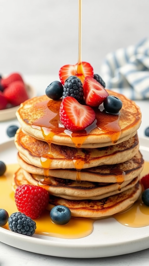 Air fryer almond flour pancakes topped with fresh berries and syrup