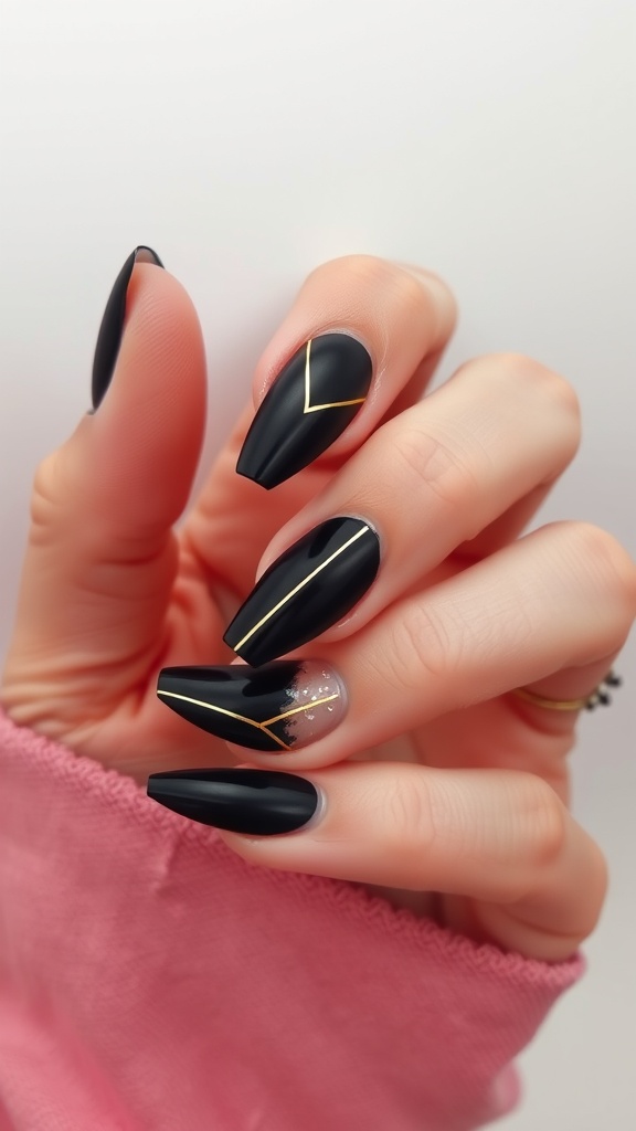Nail design featuring black polish with gold lines and a glitter accent