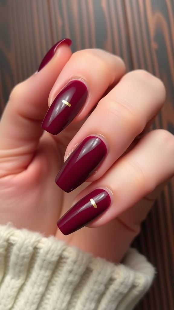 Burgundy nails with metallic gold stripes
