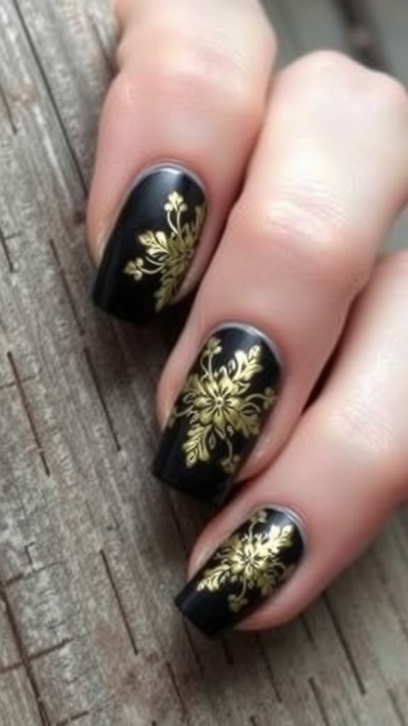 Floral black and gold nail art design on a hand.