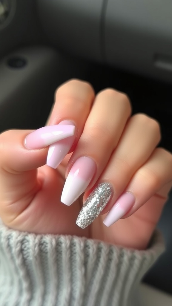 Nails featuring a pink and white gradient with a glitter accent nail