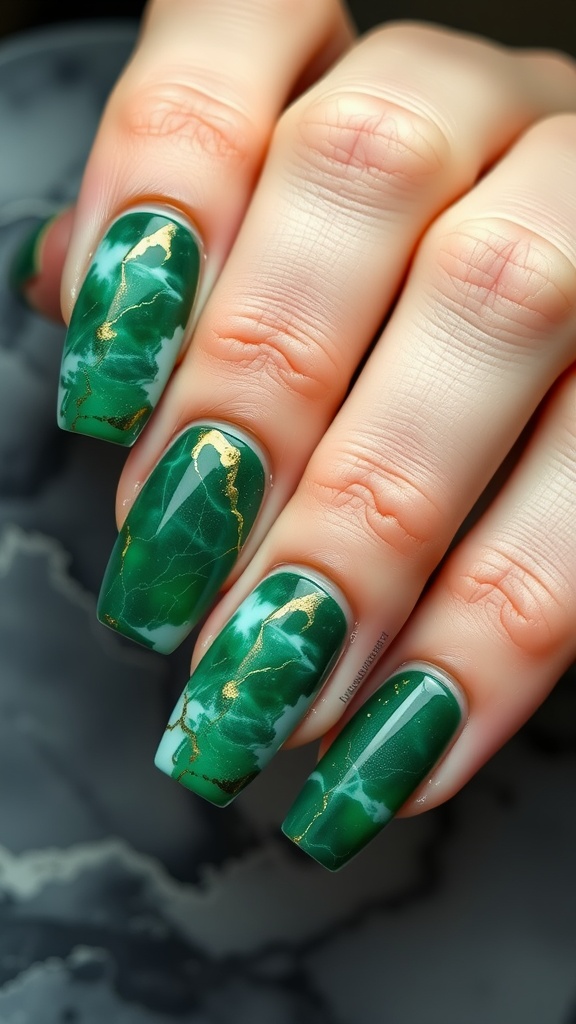 Nails featuring a marble effect design with green and gold colors.