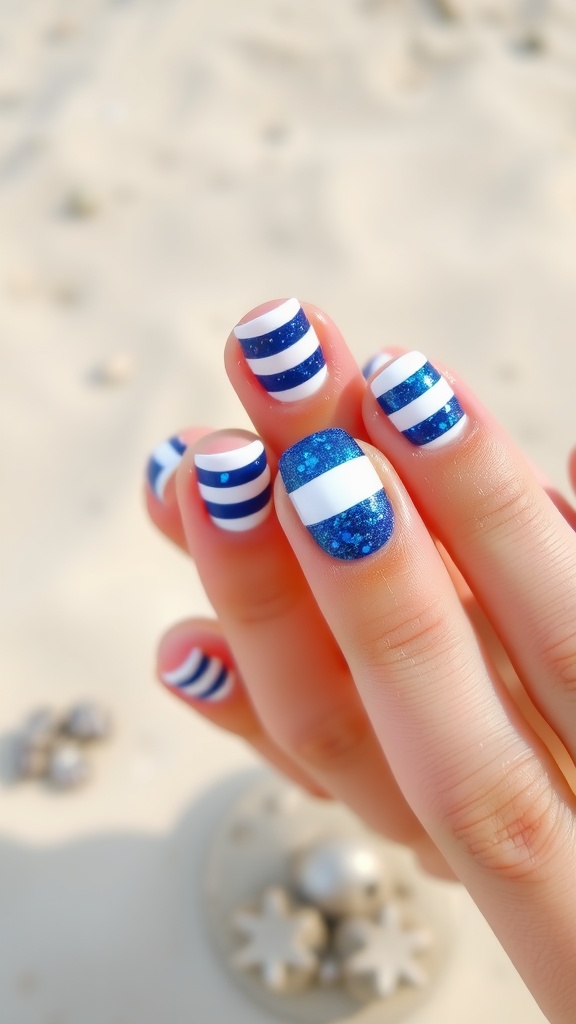 Nautical themed nails with blue and white stripes and glitter accents