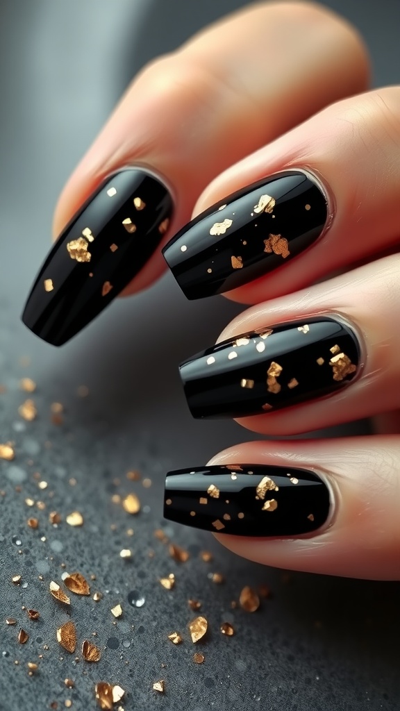 Elegant black nails with gold flakes on a dark surface.