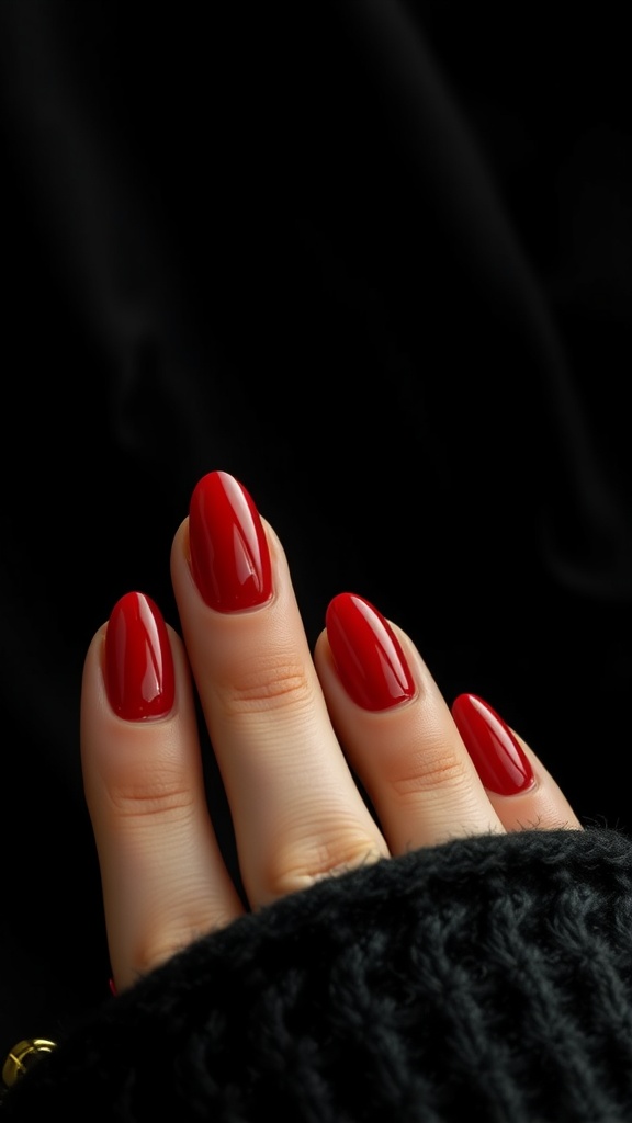 Close-up of elegant short almond nails painted in a vibrant red color