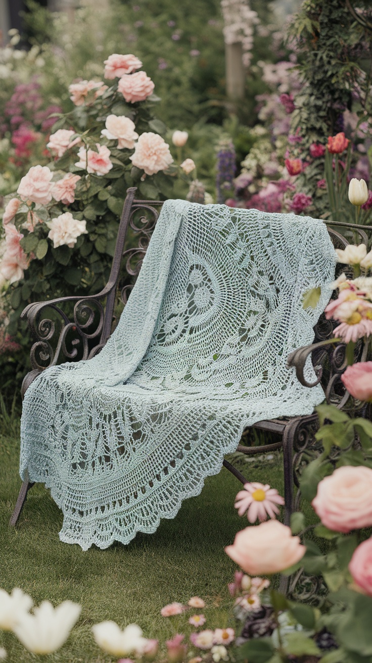 A delicate light blue crochet shawl draped over a vintage bench surrounded by blooming flowers.