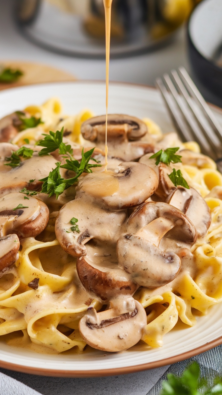 Creamy mushroom sauce drizzled over pasta with mushrooms on top