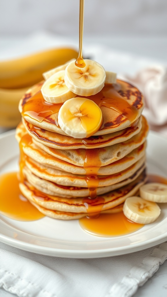 Fluffy banana pancakes stacked with banana slices and drizzled with maple syrup