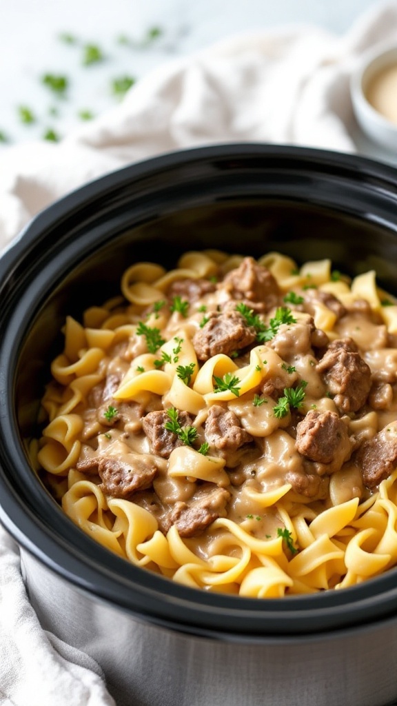 A delicious plate of Beef Stroganoff served over egg noodles in a crockpot.