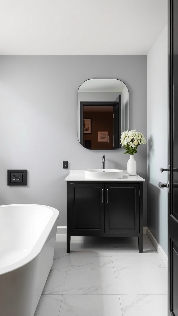 A minimalist black vanity setup in a bathroom with a white tub and grey walls.