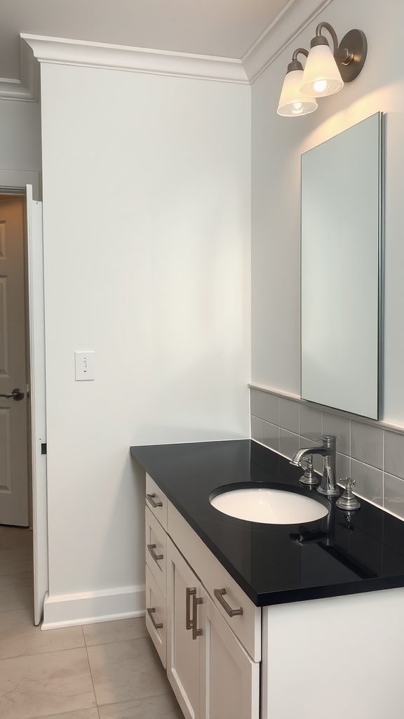 A bathroom with a black countertop and light cabinets, showcasing a modern design.
