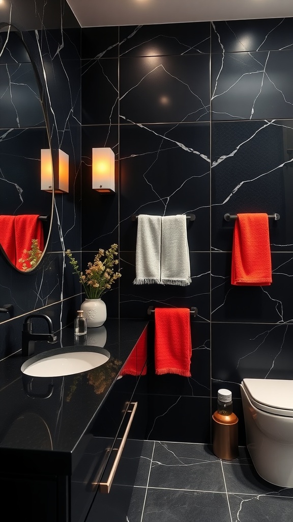 A modern bathroom featuring black countertops, red towels, and stylish lighting.