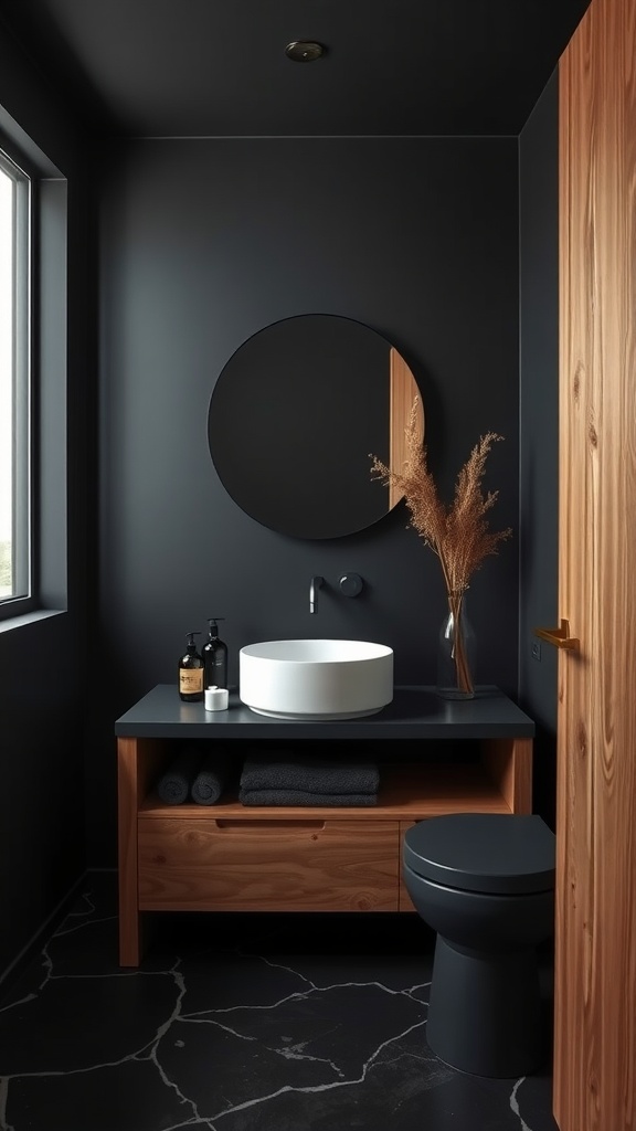 A modern black bathroom with natural wood accents featuring a round mirror and a white sink.