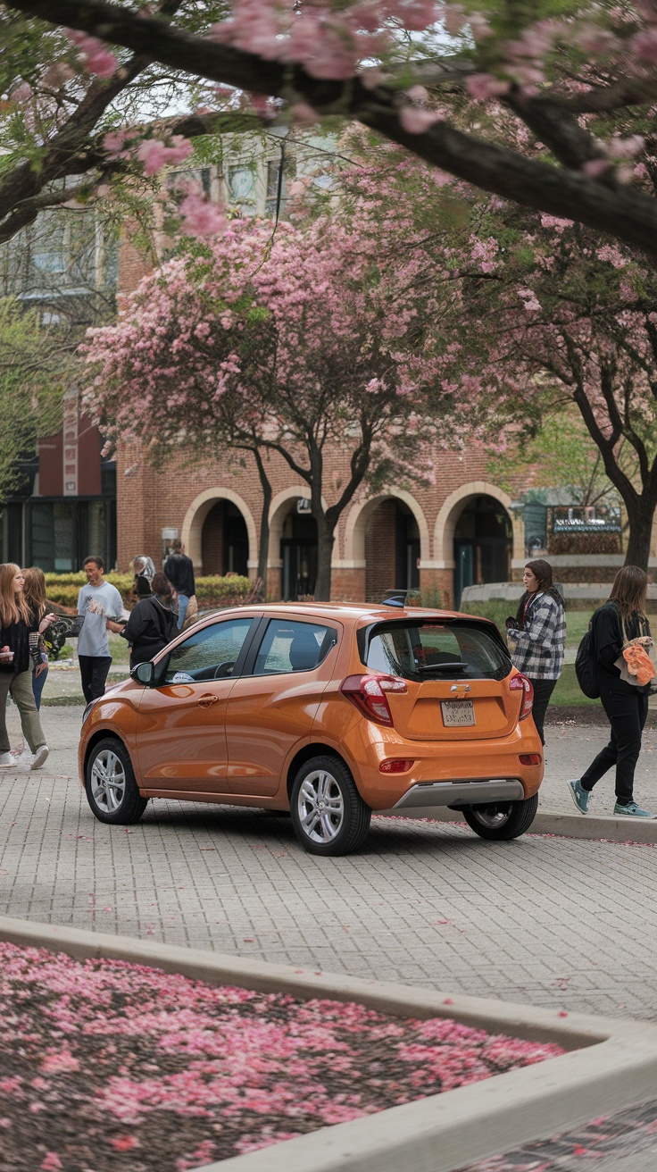 A Chevrolet Spark parked among blooming trees with people walking around.