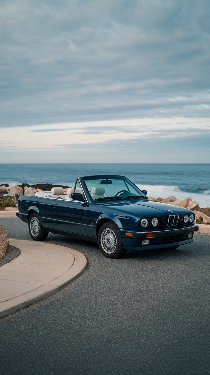 A blue BMW E30 325I Cabriolet parked by the ocean.