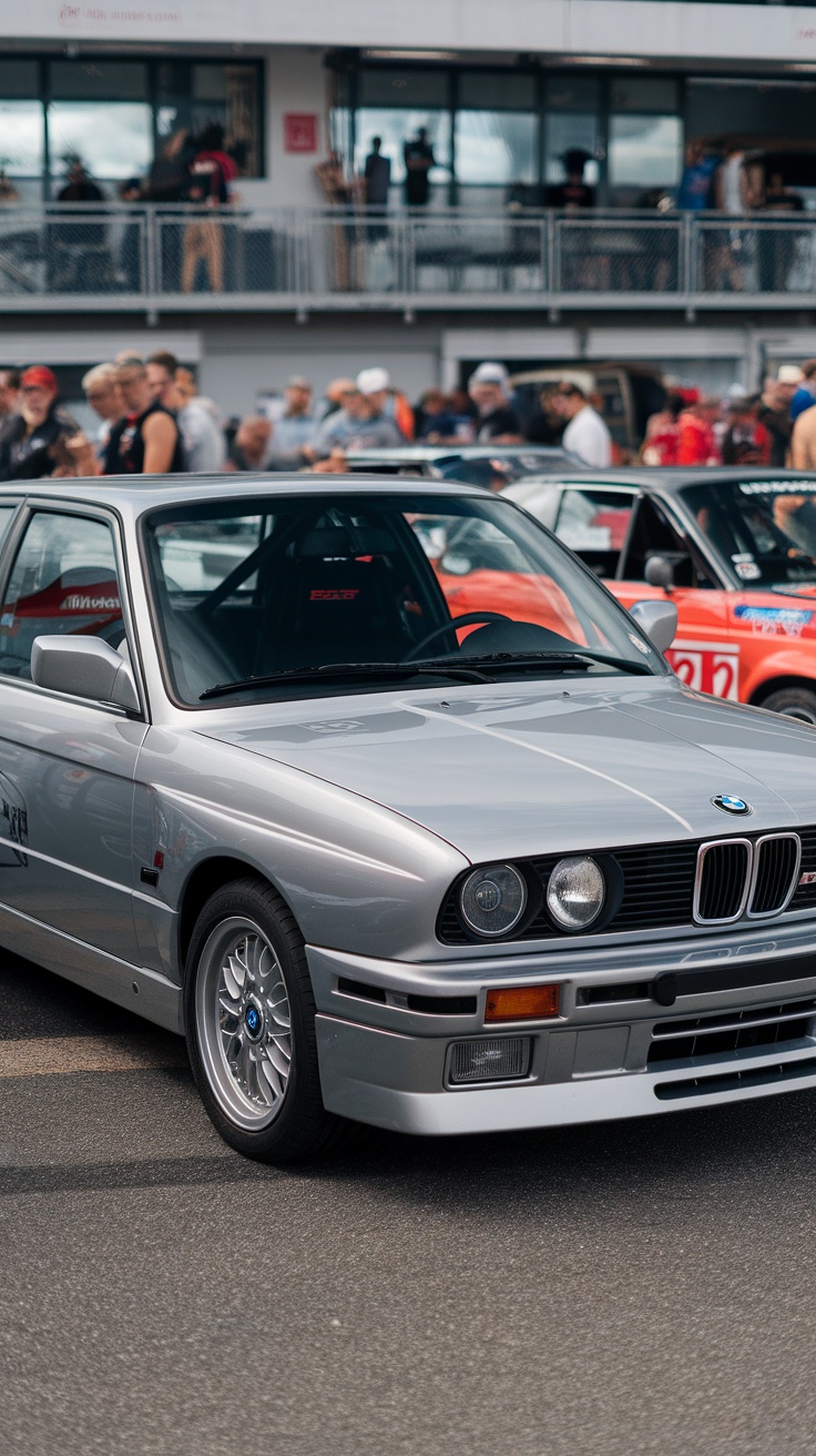 A BMW E30 325Is parked at a car event, showcasing its classic design.