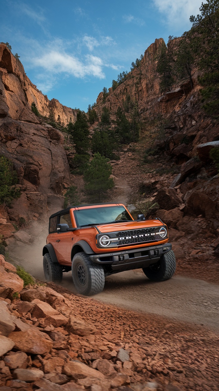 A Ford Bronco driving through a rocky trail in a mountainous area.