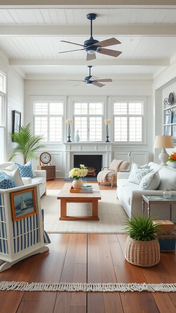 A coastal New England style living room featuring white sofas, blue accents, large windows, and wooden flooring.