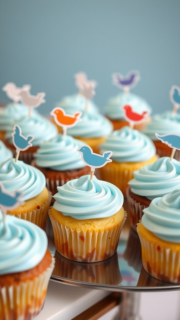 Cupcakes with baby blue frosting and colorful bird toppers