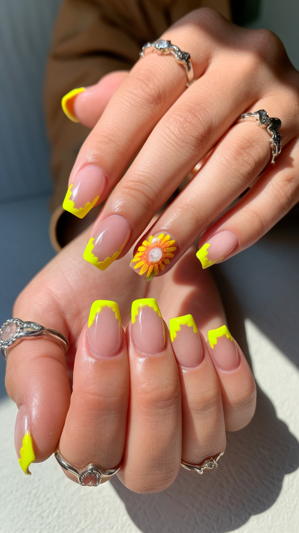 Bright yellow sunflower nail design with tips and an accent nail featuring a sunflower