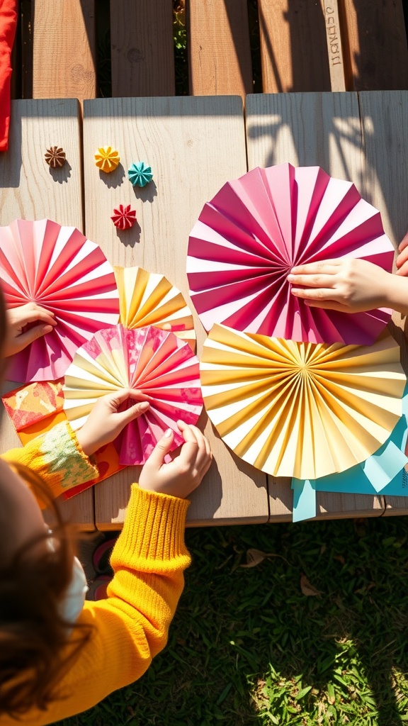 Children creating colorful paper fans with their hands on a wooden table
