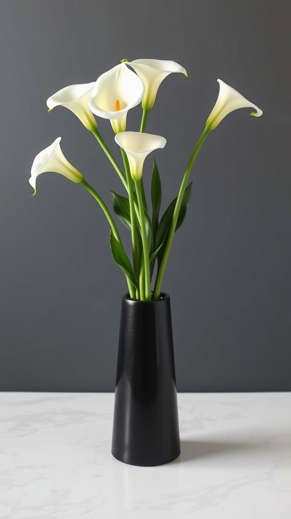 A sleek arrangement of white calla lilies in a modern black vase.