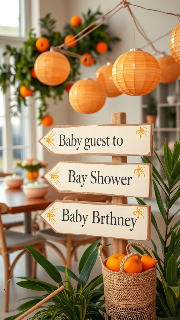 Wooden signpost with orange-themed directions for a baby shower, decorated with hanging lanterns and a basket of oranges.