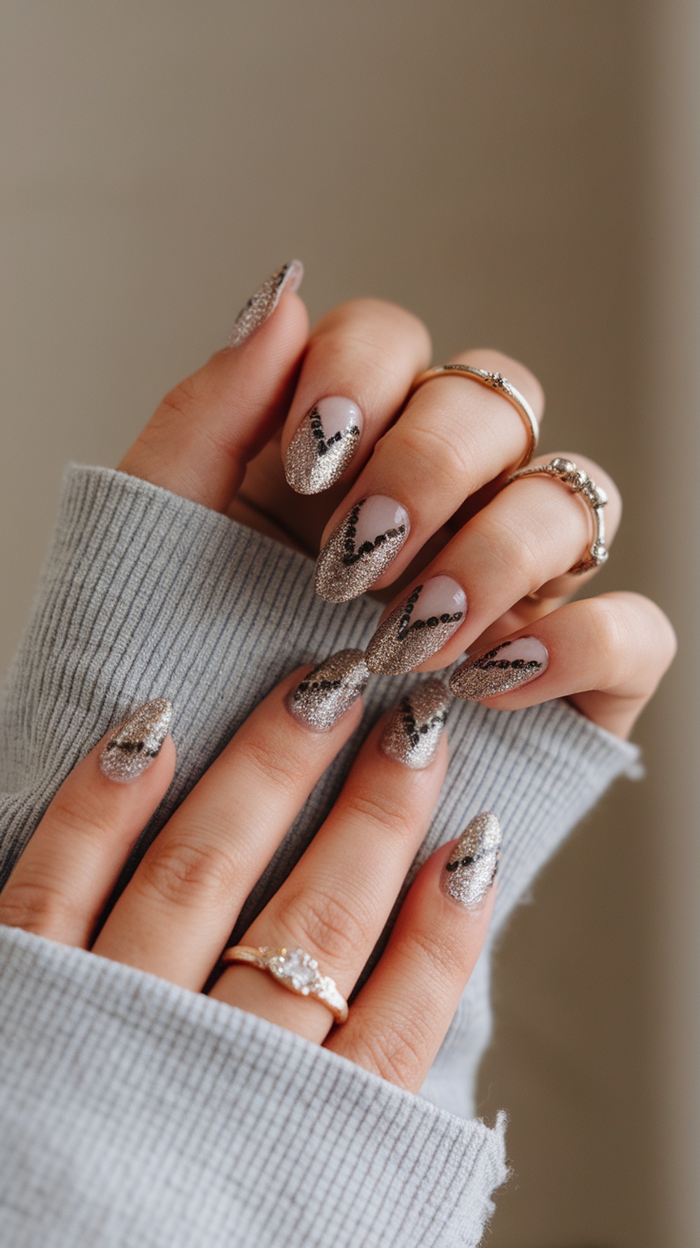 Close-up of hands with sparkly glitter nails and nail foil design